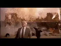 Man walking calmly through explosion