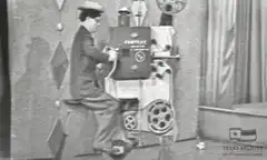 Charlie Chaplin operating a film projector