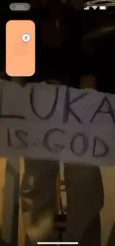 Person holding sign Luka is God