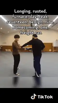 Two men practice martial arts with sticks
