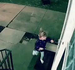 Toddler opens door with phone