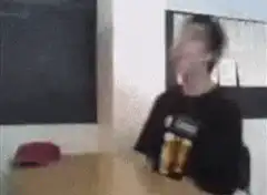 blurry guy laughing at table