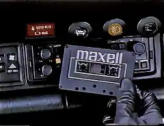 gloved hand inserts maxell cassette
