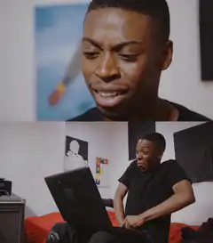 Man reacts to laptop with shock