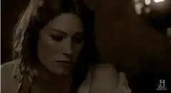 Woman looking down at sleeping man