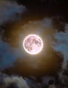 Glowing full moon in night sky