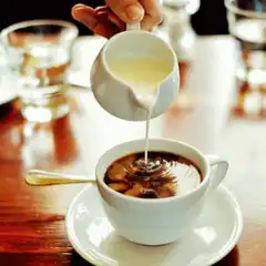 Pouring milk into coffee