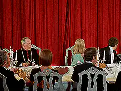 Red curtains open to reveal audience