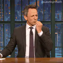 Seth Meyers eating and waving