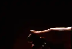 Hand spraying white liquid in slow motion