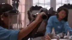 Nurse vacuuming feet and shaking man