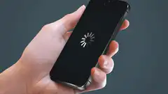 Hand holding phone with loading spinner