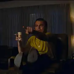 Leonardo DiCaprio pointing with coffee