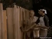 Old man painting fence with exaggerated motion