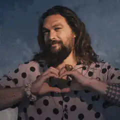 Jason Momoa makes a heart shape with his hands