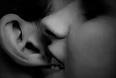 close-up of lips biting ear