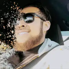 Man with sunglasses dissolving into triangles