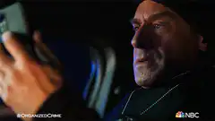 Popeye Strong looking at phone in car