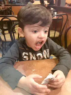 Surprised toddler at restaurant