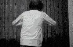 person opening curtains to bright light