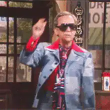 Mr. Rogers takes off his sunglasses