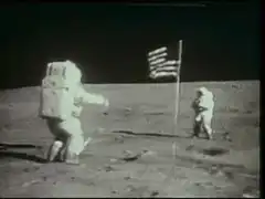 Astronauts on the moon with American flag