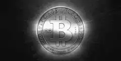 Silver Bitcoin coin with glowing light