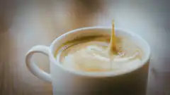 Coffee splash in a white cup
