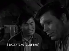 Asian man imitating gunfire