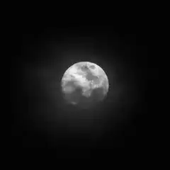 glowing moon in dark sky