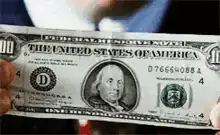 Michael Scott throws away a hundred dollar bill