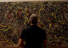 Man staring at abstract painting