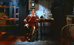 Man sitting in a chair in a dim room