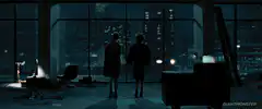 Two people holding hands looking at city lights