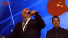 Man singing passionately on stage