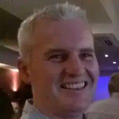 Man with gray hair smiling broadly
