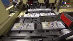 Stacks of hundred dollar bills on a conveyor belt