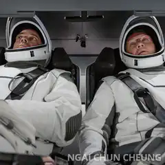 Astronauts look up at woman hanging upside down