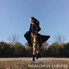 Woman levitating in black coat
