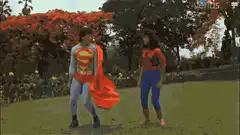 Superman and Spider-Man dancing in a park