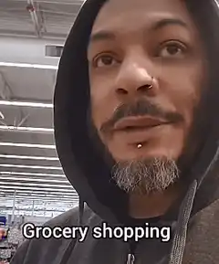 Woman eating cucumber in grocery store
