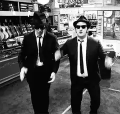 Two men in suits dancing in a music store