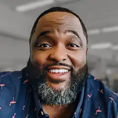 Man in flamingo shirt smiling
