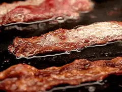 bacon sizzling in pan