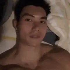 shirtless man flexing in bed