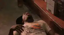 Man laughing on floor in store