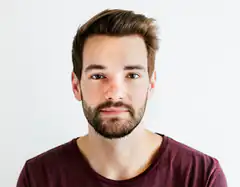 Man with beard looking at camera