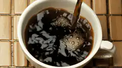 Coffee being poured into a white mug