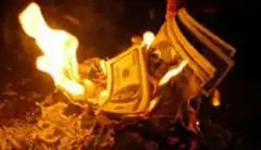 stack of dollar bills burning in fire