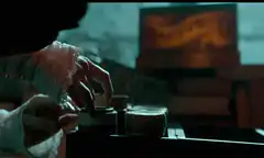 Woman winding a gramophone